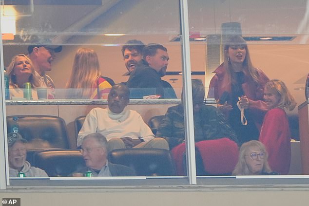 Swift is pictured in a luxury suite with Kelce's mother Donna seen in the front row