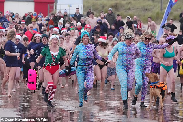 Going with tradition: Despite yesterday's tragedy, thousands took to the beaches today for their traditional Boxing Day dip in the sea. Pictured: Tynemouth Beach