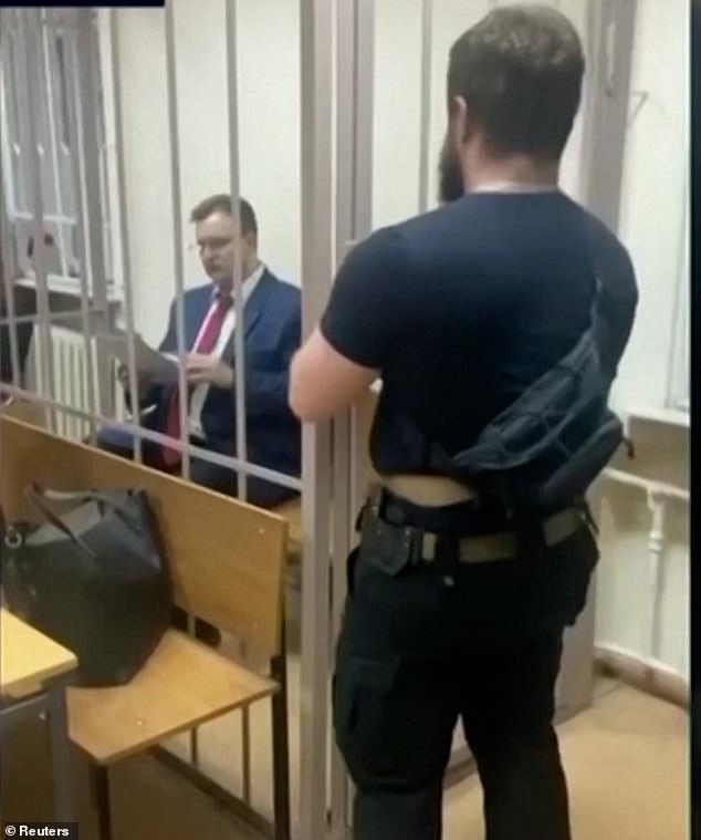A separate video shows the 38-year-old diplomat behind bars as he awaited his trial