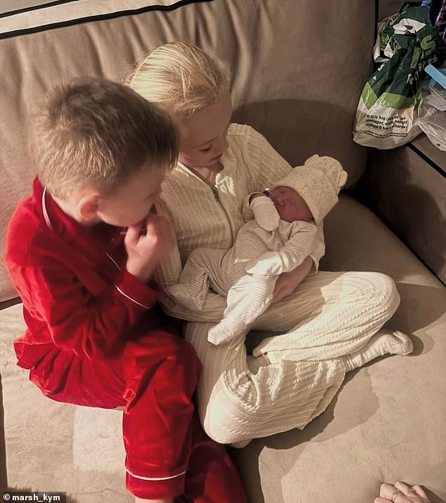 The children were clearly enjoying their new sibling as they were pictured again holding little Bobby on their sofa