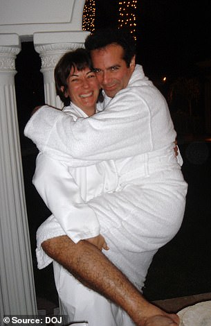 Maxwell is pictured with magician David Copperfield, both wearing white robes