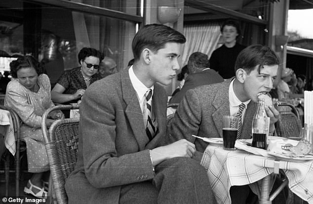 July 18, 1953: Edward George, Duke of Kent (right) and his friends celebrate the end of their final term at Le Rosey boys' school in Geneva with a visit to a local cafe