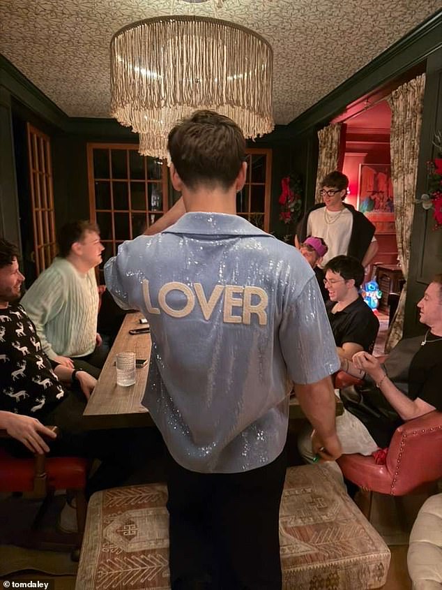 In another snap, Tom donned a blue sequin shirt, which was emblazoned with the word 'lover', as he spent quality time with his family