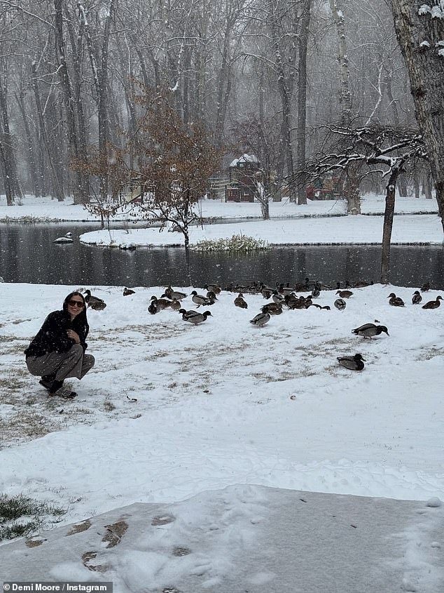 Wrapping up warm for the outing, Demi donned a black jumper and beige trousers as she posed beside a lake
