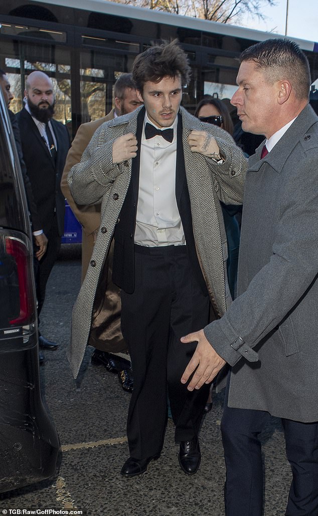 Meanwhile, Cruz, 20, arrived in a grey tweed coat layered over his tuxedo, stepping out with his family