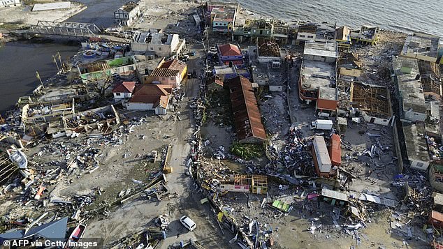 Jamaica was hit by the 'storm of the century' as Hurricane Melissa made landfall, costing at least $8 billion (£5.9 billion). Pictured: Destroyed houses in St. Elizabeth, Jamaica