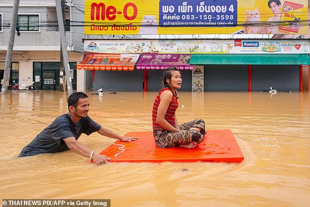 Four of the six most costly climate disasters were in Asia, including cyclones that struck Southeast Asia, causing $25 billion (£18.5) in damage and killing more than 1,750 people. Pictured: People flee flood waters in Hat Yai, Southern Thailand