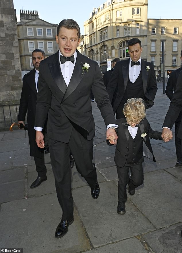 George looked incredibly sweet as he matched with his father in a black tuxedo fitted with a waistcoat and white flower pinned to his jacket
