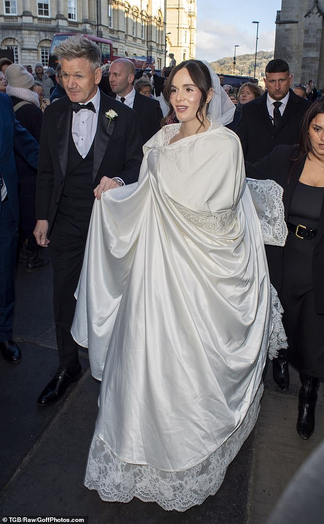 Holly Ramsay, 25, looked the vision of perfection as she wore a white silk cover with a lace trim over her wedding dress