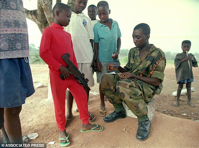 A 12-year-old fighter seen with his gun in January 1997. He was recruited to fight in the war when he was just eight