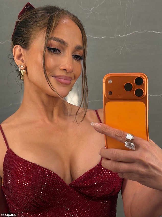 But her Christmas dinner array was tainted when she posted a selfie that fans instantly recognized as being a bad photoshop job, as the bottom of her phone appeared to be bending sideways