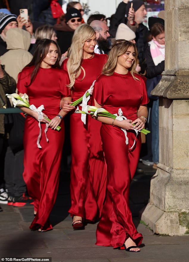 The bridesmaids all wowed in satin red dresses as they arrived at Bath Abbey to watch Holly and Adam tie the knot in front of their friends and family including the Beckhams