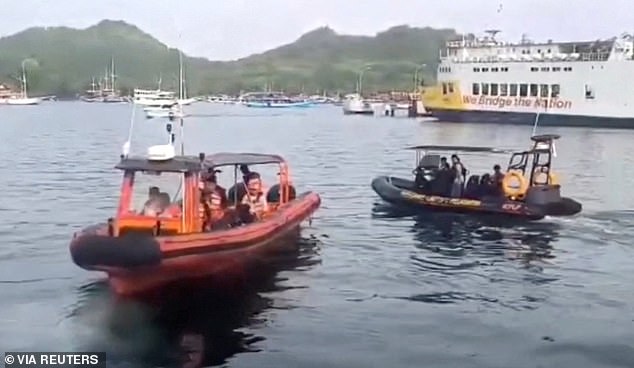 Rescue teams search for survivors after a tourist boat sank in rough seas off Indonesia