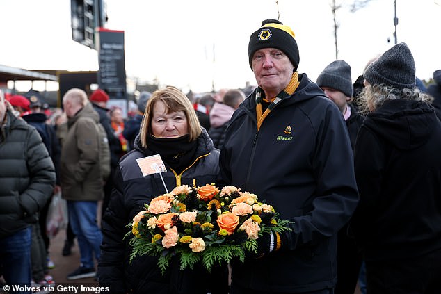Wolves fans pay their respects ahead of the game by laying a wreath