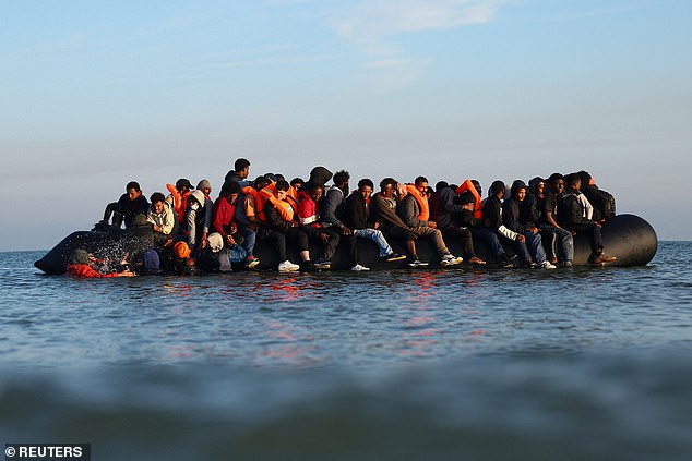 A group of migrants on an inflatable dinghy leave the beach of Petit-Fort-Philippe in northern France in an attempt to cross the English Channel to reach Britain in September 2025