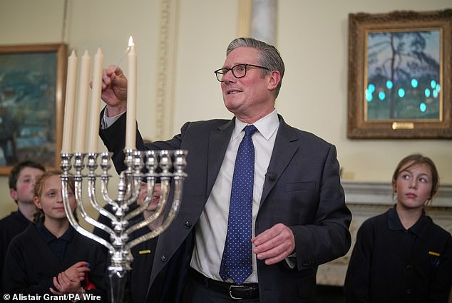 Sir Keir Starmer lights a candle during a Downing Street event to mark Hanukkah
