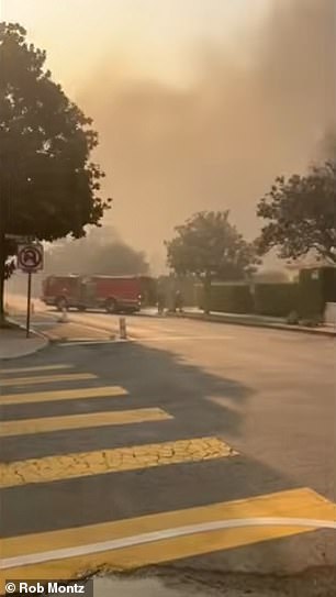 A fire truck sitting idly down the street from the church