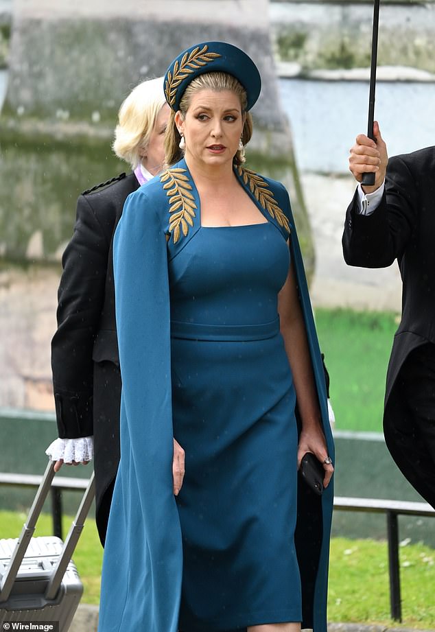 Former Tory cabinet minister, Penny Mordaunt arrives at Westminster Abbey for the Coronation of King Charles III and Queen Camilla wearing a Safiyaa gown