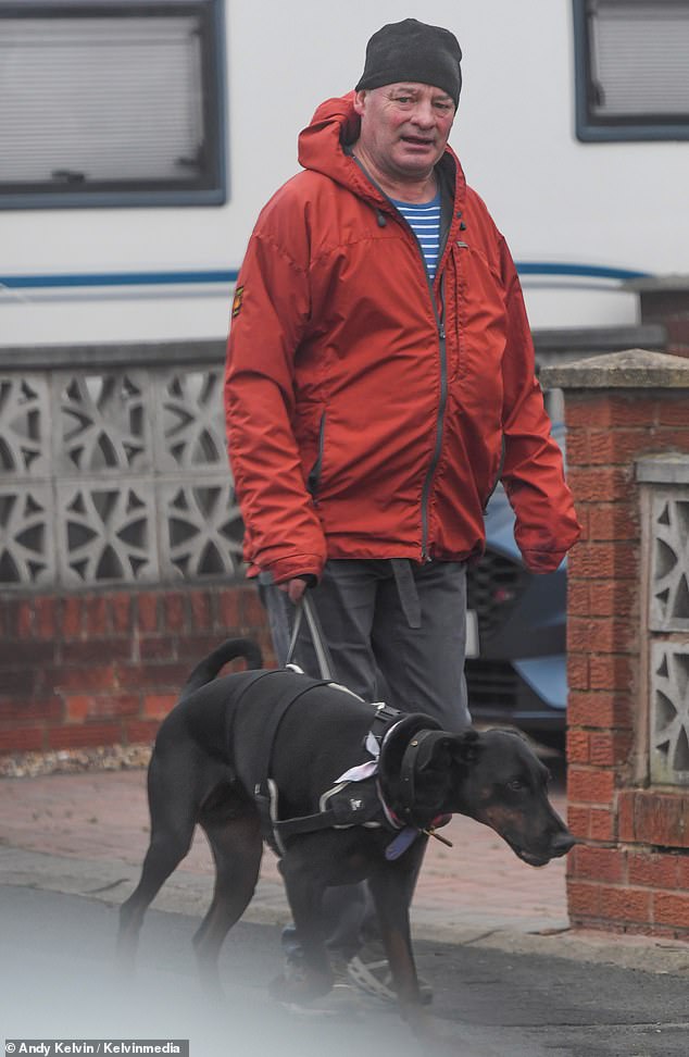 Mark wrapped up in an eye catching orange coat as he stepped out after it was revealed he was invited to the wedding at Bath Abbey, but was told he would have to sit in the back row