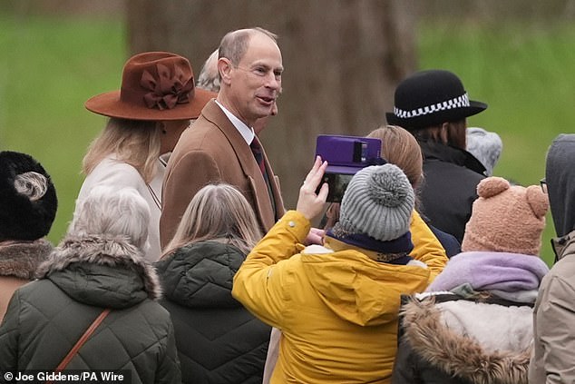 Prince Edward, 61, smiles at members of the public taking snaps of the royal brood as they head to the church