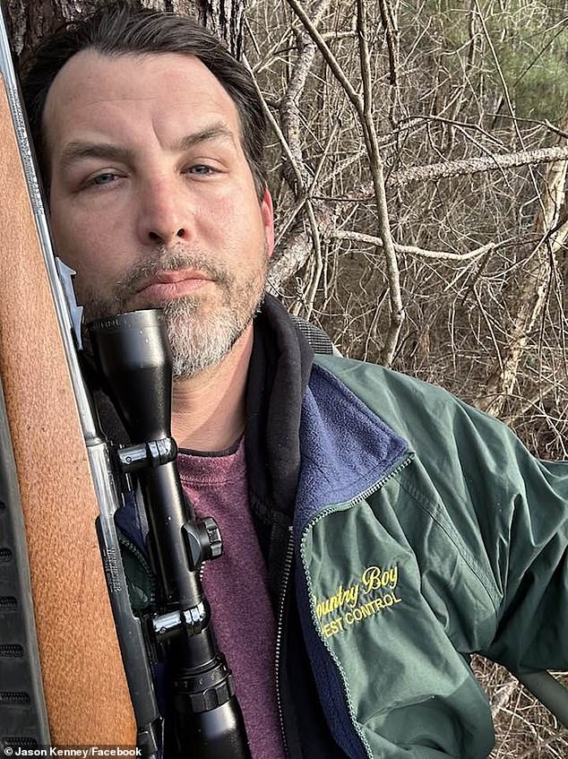 Kenney posing with a gun while in a pest control company's uniform