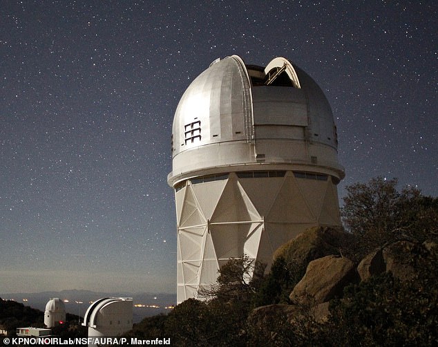 TKTK. Above, a nighttime photo of the Dark Energy Spectroscopic Instrument (DESI) installed at the Kitt Peak National Observatory near Tucson, Arizona