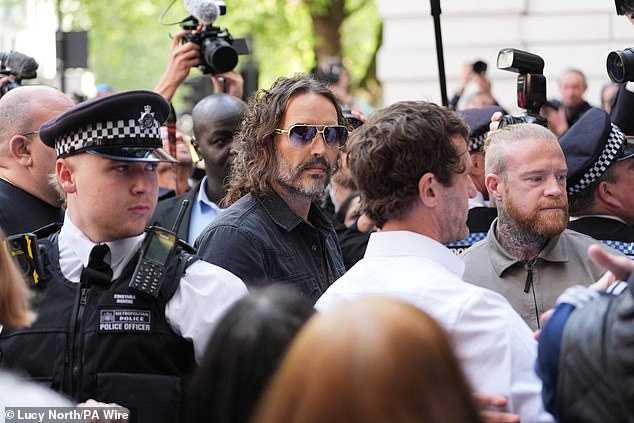 He arrived wearing gold rimmed sunglasses, a black shirt and trousers