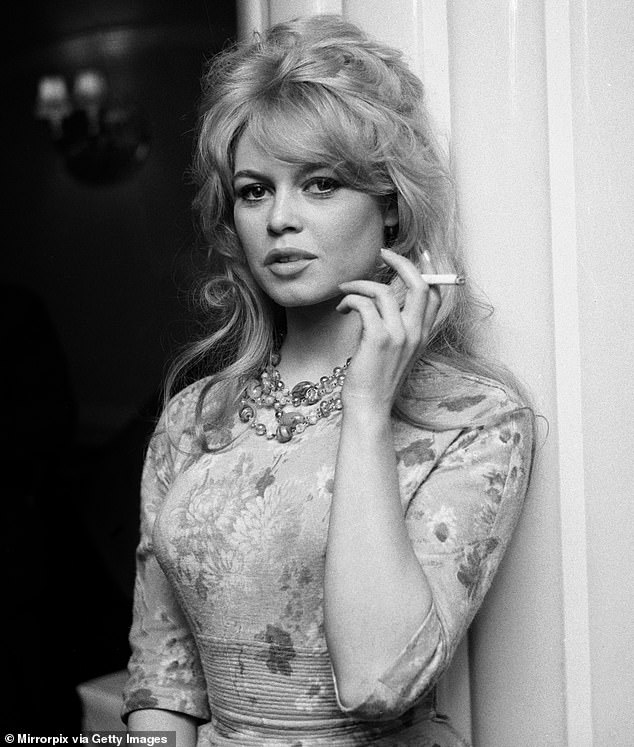 Brigitte Bardot pictured smoking a cigarette after arriving in London, April 1959