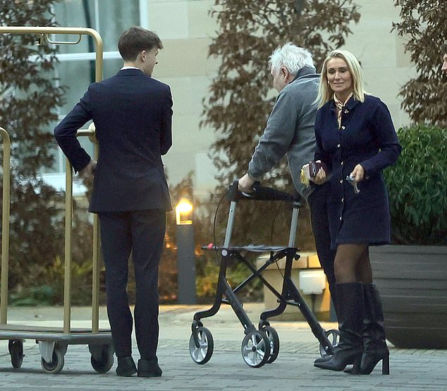 In another look a few days later, Katie put on a leggy display in a trendy denim dress which she paired with knee high black leather boots