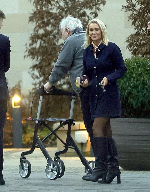 Katie looked stylish for Christmas Eve as they appeared to head towards one of the parks restaurant