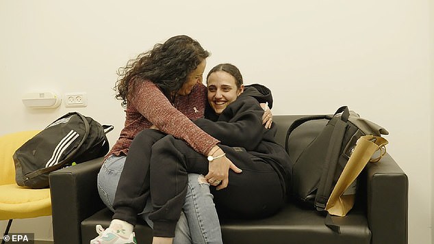 Released hostage Romi Gonen (R) embracing her mother Merav (L) at a reception point near Kibbutz Reim, southern Israel, 19 January 2025