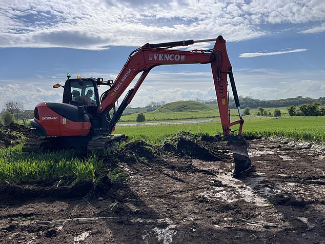 A digger pictured beginning the excavations in front of Skipsea Castle, which is now just a mound