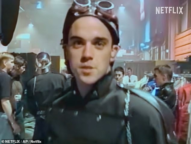 Meanwhile in another throwback clip, a young and cheeky Robbie, who himself quit Take That in 1995, joked: 'We all kissed before the show... in a butch way!' (Robbie pictured)