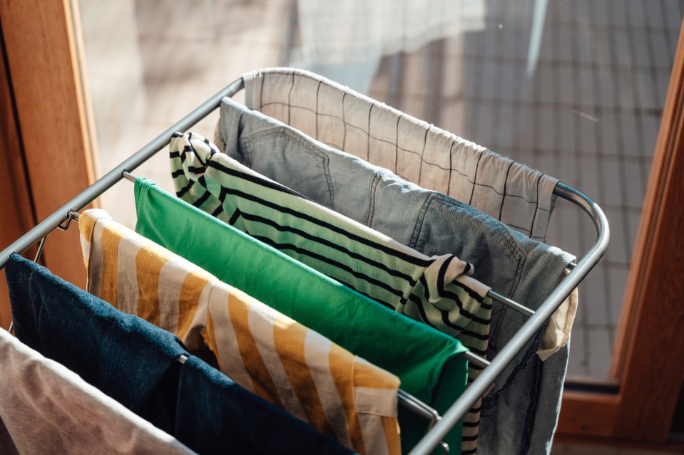 Clean laundry hanging on drying rack