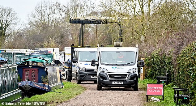 Work vans are pictured arriving at the scene one week after a stretch of the Llangollen Canal in Whitchurch, Shropshire, collapsed