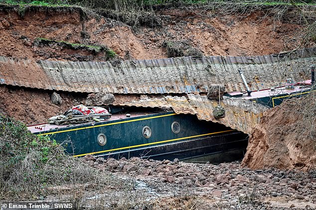Pictures show the vessels submerged in mud with bits of debris scattered round them and a long stretch of corrugated metal draped over