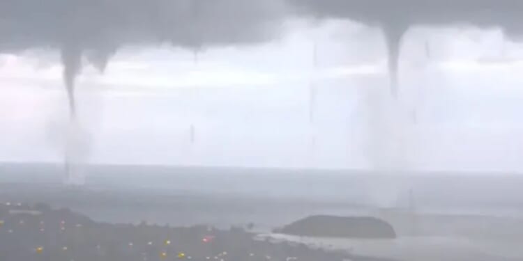 Moment THREE waterspout tornados strike at the same time off the coast of Spain in freak natural event