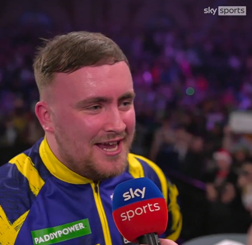 Luke Littler speaking into a Sky Sports microphone.