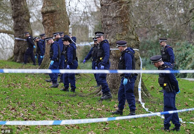 Police officers conduct a fingertip search on Primrose Hill on New Year's Day 2024