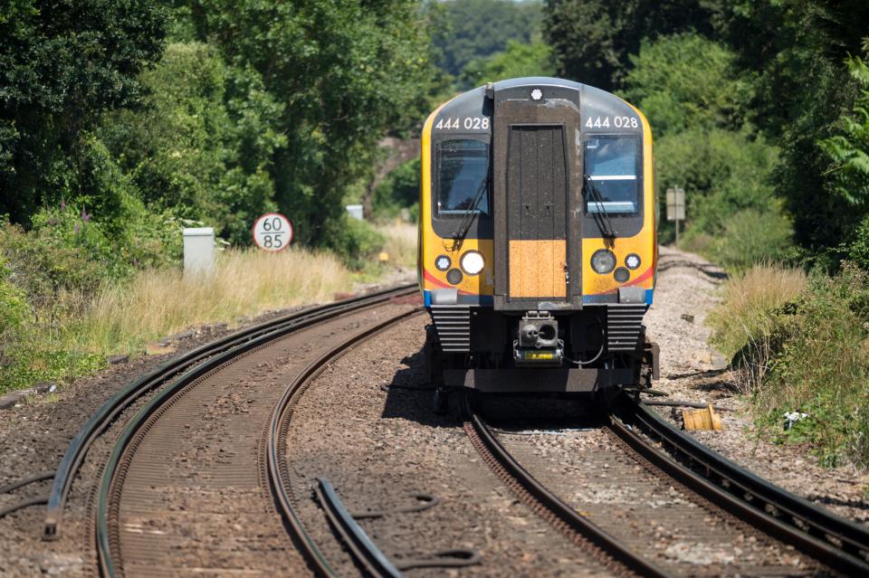 Delayed due to speed limits in hot weather, South Western railway 444 Class commuter train south bound between London Waterloo and Portsmouth through