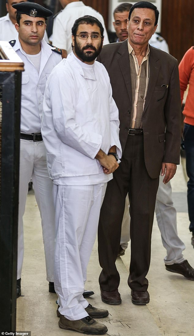 El-Fattah (pictured) one of the 25 detained activists of January 25 Revolution in Egypt, is seen during the Shura Council trials at the Cairo Police Academy in Cairo, Egypt, on November 2014