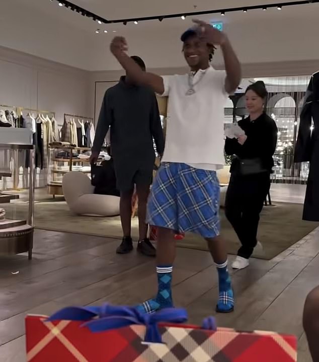 The rapper was seen in one clip dancing around the Burberry store, making gang signs