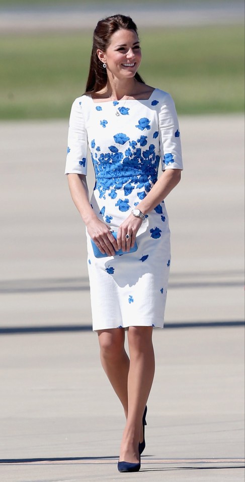 Catherine, Duchess of Cambridge, in a white LK Bennett dress with blue floral patterns, carrying a blue clutch.