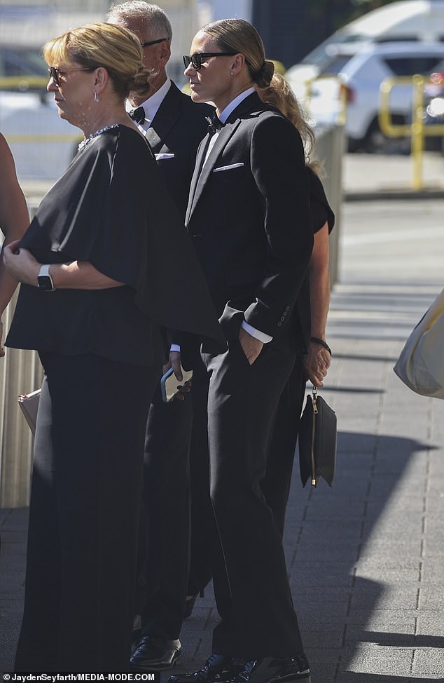 Matildas midfielder Emily Van Egmond (centre), who also got married at the end of last year, looked suave as she donned a black tuxedo and a pair of black shades