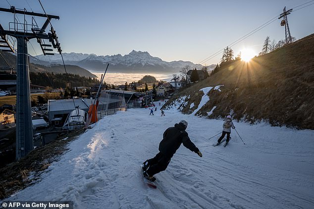 As snowfall becomes more and more unpredictable across Europe's top skiing destinations, conversations are now being raised over the future and state of these landscapes. Pictured: A skier slips down a poorly snow-covered access slope in the resort of Leysin on December 27, 2025