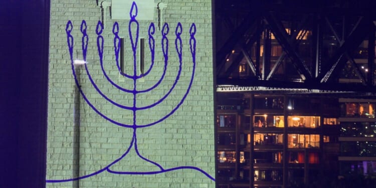 Sydney holds tribute to Bondi terror victims before New Year fireworks as Harbour Bridge is lit up in Jewish Menorah