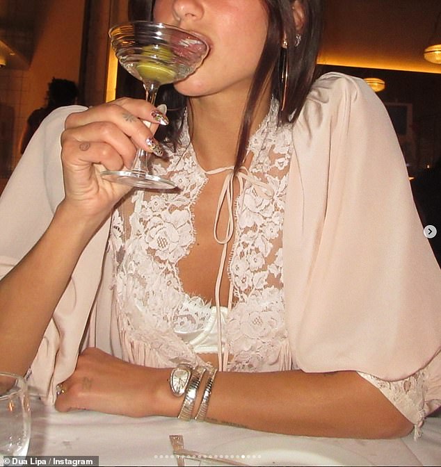 Dua Lipa enjoyed a cocktail after jetting back from Mexico to see in the New Year in chilly UK