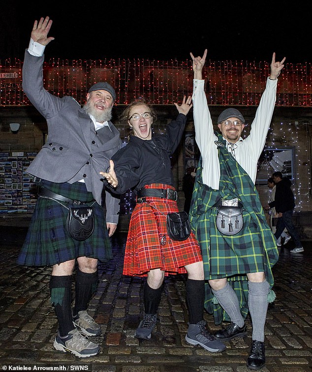 Jamie and Titus Crabtree with Thomas Horton III from America wear kilts to celebrate Hogmanay 2026 in the Scottish capital city