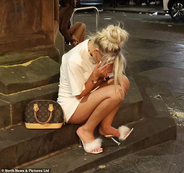 One young girl covers her face while in the city centre of Newcastle tonight