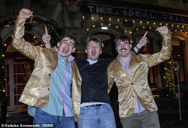 Revellers sporting gold jackets in Edinburgh celebrate the 2026 Hogmanay